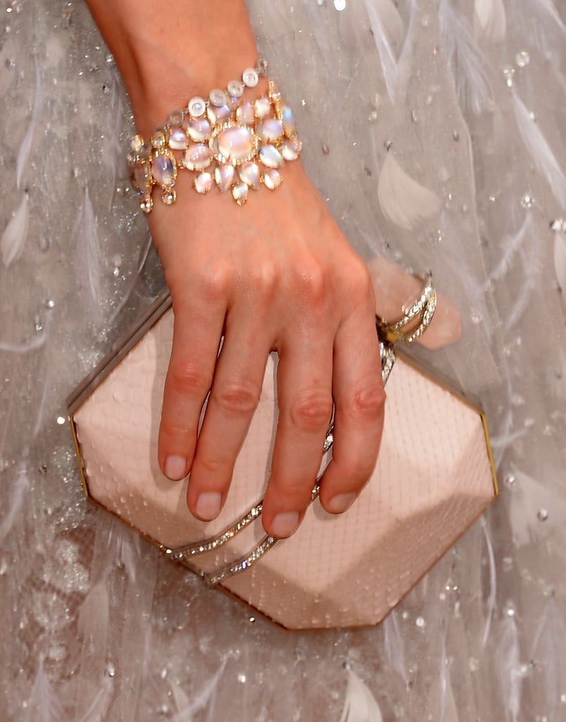 Sarah Paulson picked a pretty pale Marchesa clutch and an armful of Irene Neuwirth jewels.