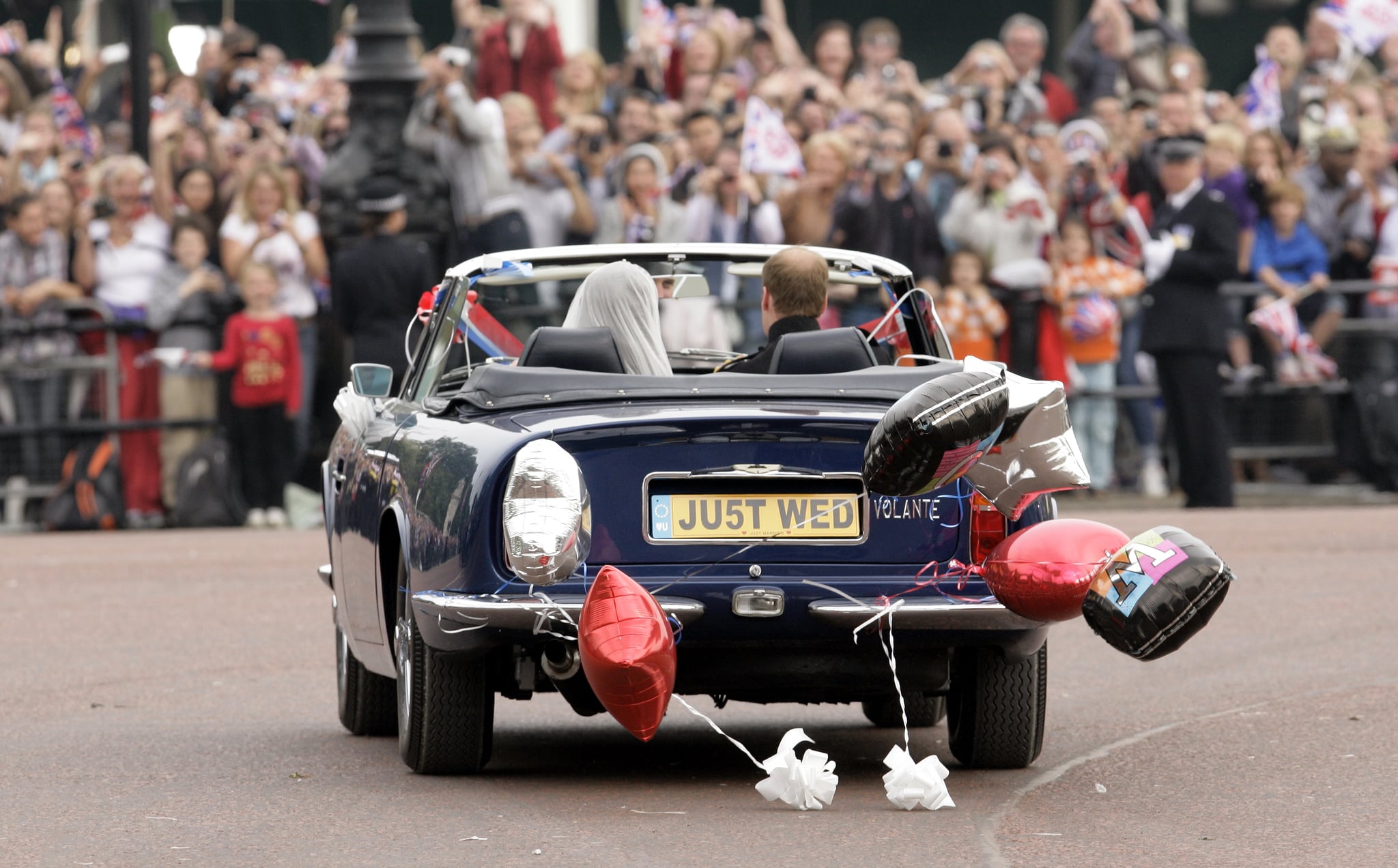 LONDON, UNITED KINGDOM - APRIL 29: (EMBARGOED FOR PUBLICATION IN UK NEWSPAPERS UNTIL 48 HOURS AFTER CREATE DATE AND TIME) Prince William, Duke of Cambridge and Catherine, Duchess of Cambridge leave Buckingham Palace after their Wedding reception in Prince Charles' vintage Aston Martin DB6 Volante on April 29, 2011 in London, England. (Photo by Indigo/Getty Images)