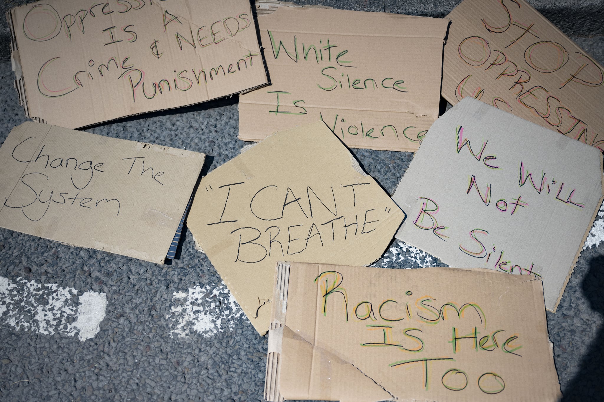 CARDIFF, WALES - MAY 31: Signs left behind following a protest outside Cardiff Castle in response to the death of George Floyd on May 31, 2020, in Cardiff, Wales. African-American George Floyd, 46, died in police custody after being arrested outside a shop in Minneapolis, Minnesota. Footage of the arrest shows a white police officer, Derek Chauvin, kneeling on George Floyd's neck while he was pinned to the floor. The death has lead to protests across the US. (Photo by Matthew Horwood/Getty Images)