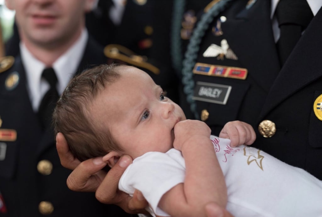 Daughter of Fallen Soldier Photographed With Army Members