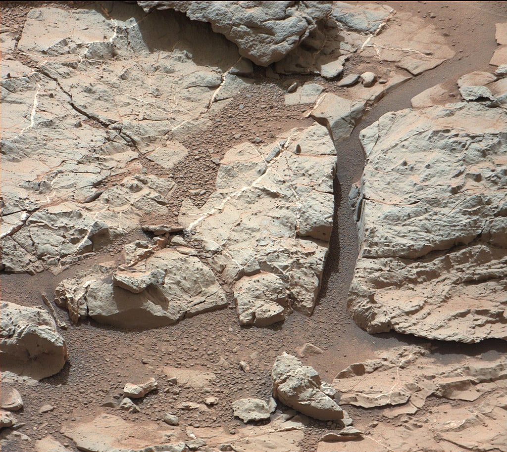 Here's a picture taken at a location called "Sheepbed," which shows well-defined veins filled with whitish minerals that we think is calcium sulfate. The veins form when water circulates through fractures, depositing minerals along the sides of the fracture.
Source: NASA/JPL-Caltech/MSSS Here's a picture taken at a location called "Sheepbed," which shows well-defined veins filled with whitish minerals that we think is calcium sulfate. The veins form when water circulates through fractures, depositing minerals along the sides of the fracture.
Source: NASA/JPL-Caltech/MSSS