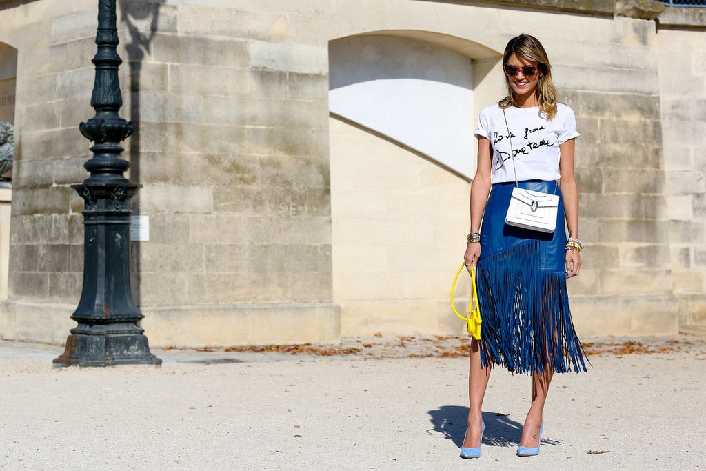 Helena Bordon paired a casual tee with a blue fringed skirt and a pop of contrasting yellow with her bag.