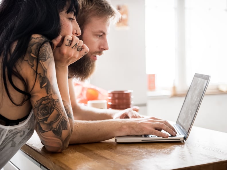 Young Couple Looking at Laptop