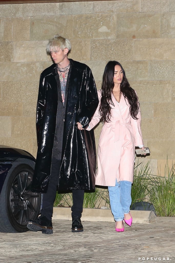 The duo stepped out in matching PVC trench coats for a double date with Mod Sun and Avril Lavigne — Megan in pretty pink and MGK in cool black.