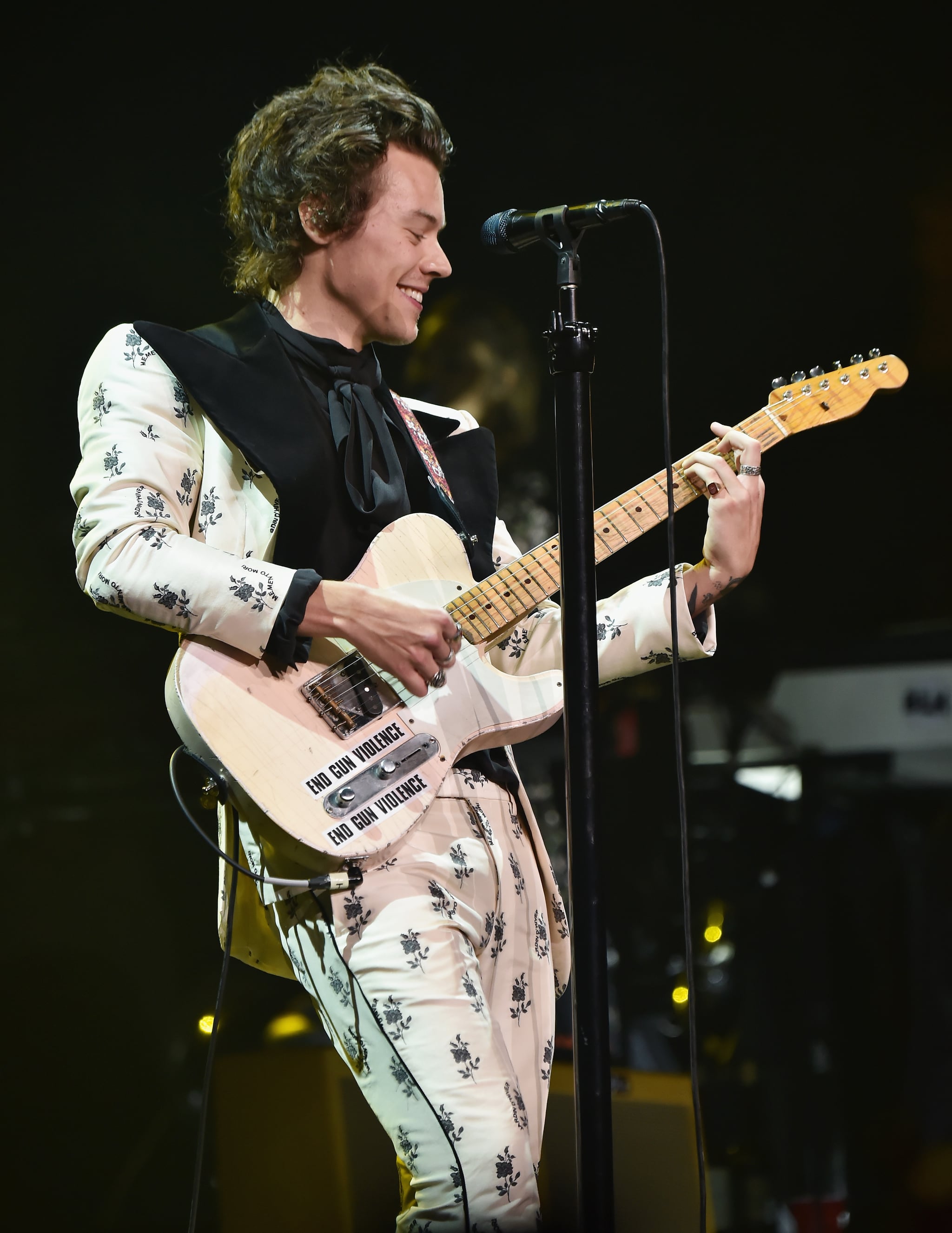 NEW YORK, NY - JUNE 21:  Harry Styles plays a guitar with the words 