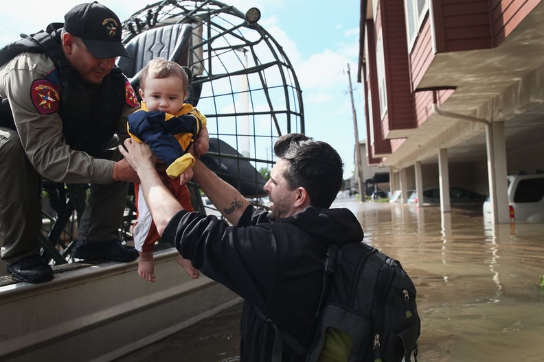 A baby being rescued on Aug. 30 after the family's apartment complex was flooded in Houston.