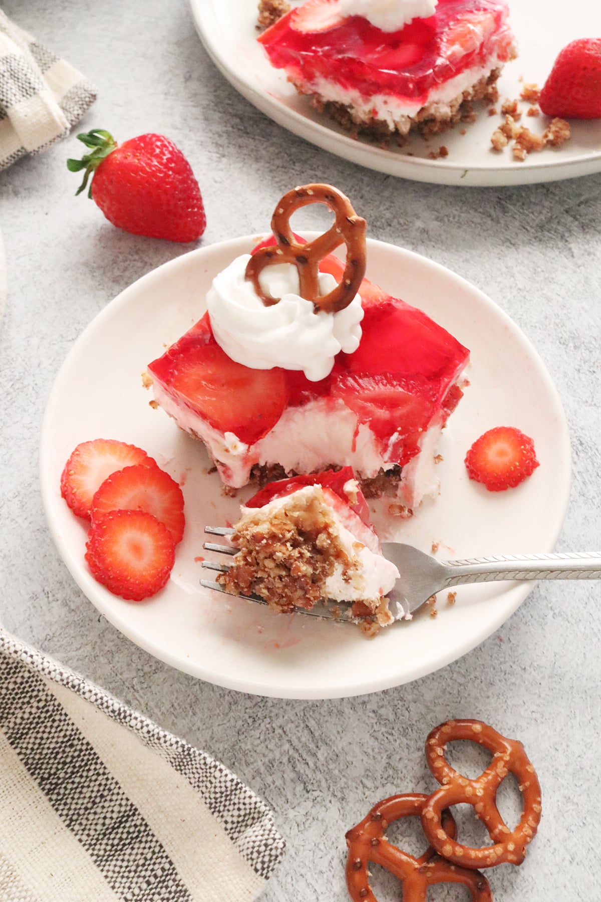 Slice of strawberry pretzel salad on a white plate