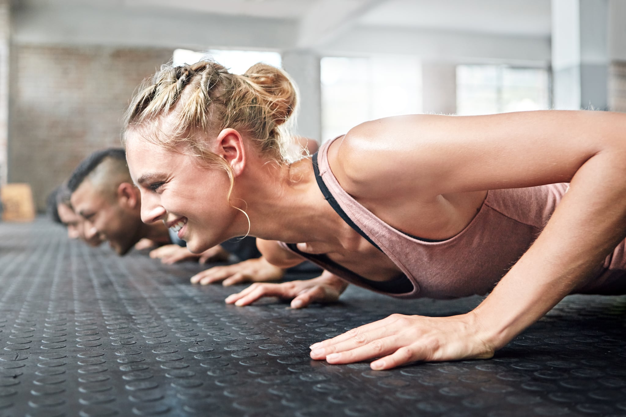 Shot of a group of people doing push ups in a gym