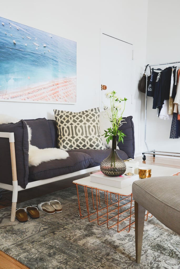 This cozy seating area, complete with a marble and copper coffee table and patterned throw pillow, is perfect for brainstorming sessions and magazine breaks. The framed beach print overhead adds to the ambiance. This photograph is by Jay Ezra, but you can find similar styles by Gray Malin.
Photo by Claire Esparros via Style Me Pretty