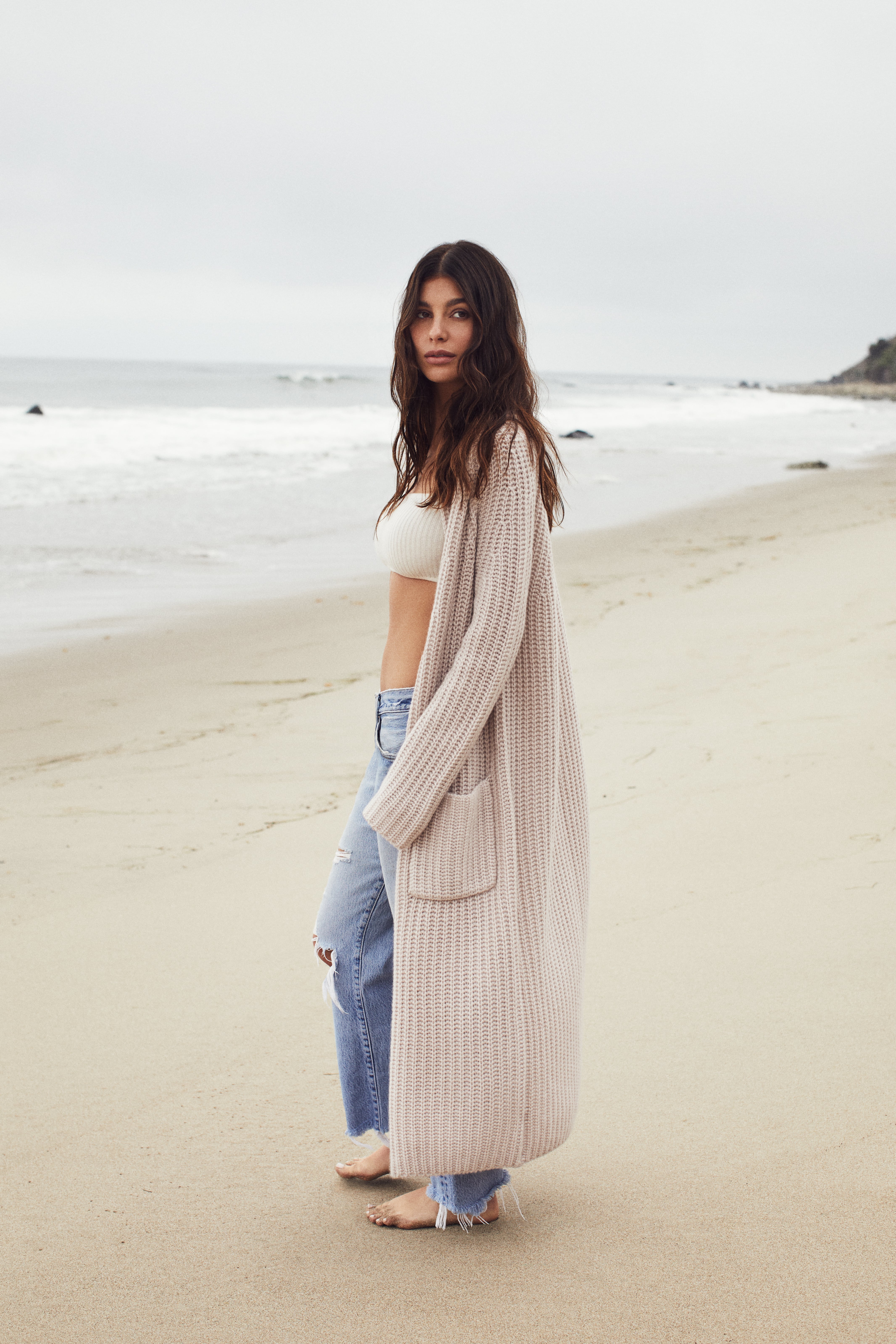 Camila Morrone looks chic in a beige turtleneck sweater and black