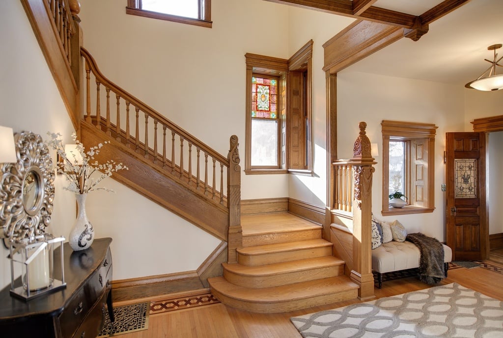 Vaulted ceilings and a wooden staircase lead to the second story of the home.
