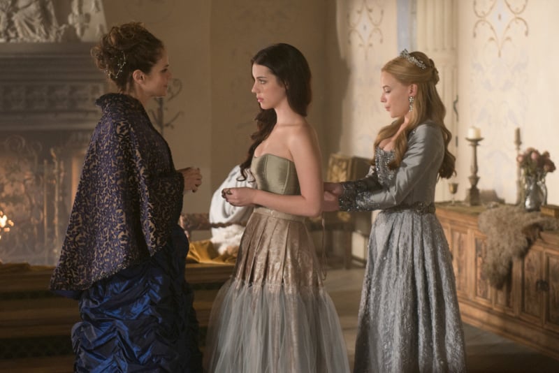 Greer (Celina Sinden) cinches Mary (Adelaide Kane) into her undergarments.