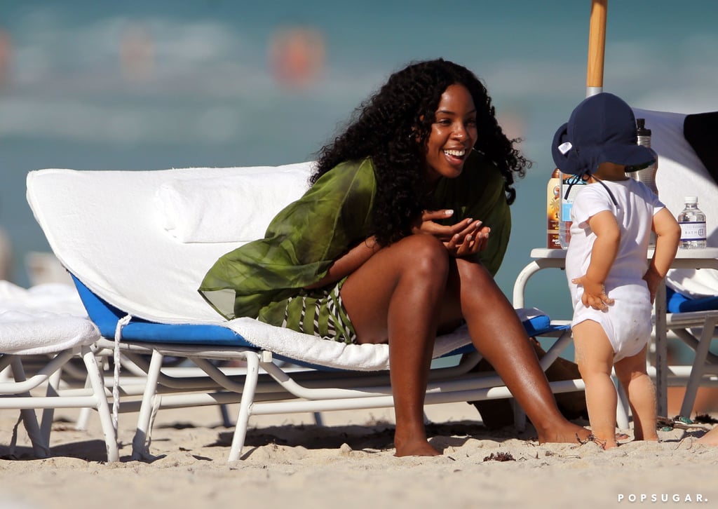 Kelly smiled and cooed at a cute toddler on the beach.