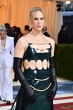 Tommy Dorfman Rocks Rubber Cutout Gown and “Protect Trans Kids” Bag at the Met Gala