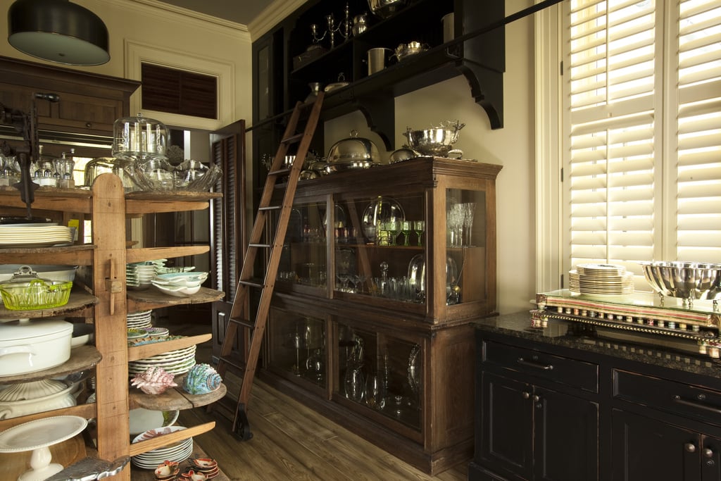 Cooking supplies are stylishly stored in a spacious English pantry.