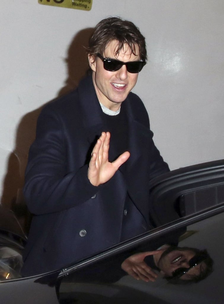 Tom Cruise went out with a smile during a break from filming Mission: Impossible 5 in London on Wednesday.