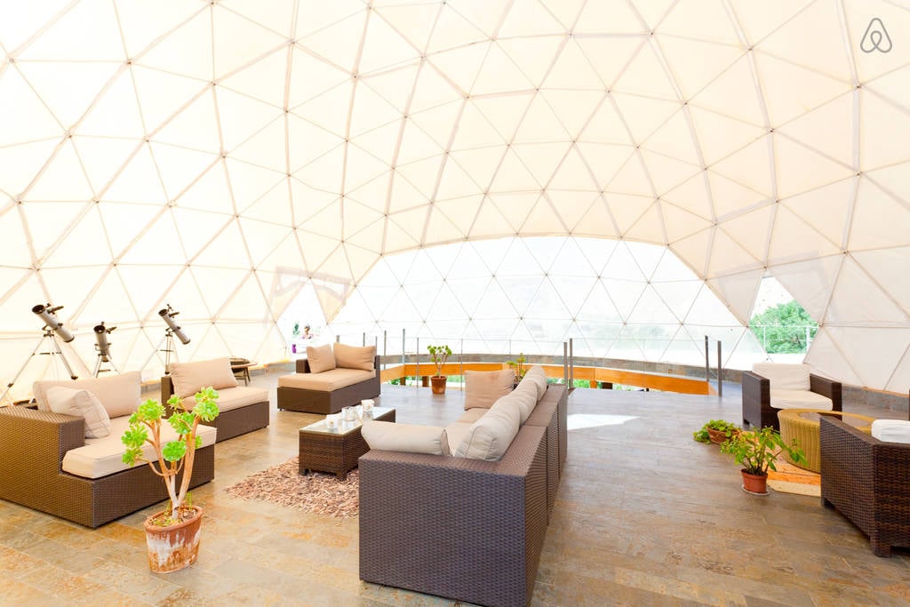 For a little less than $200 a night, you can stay in one of the two-story geodesic domes complete with a living room, bathroom, and main bedroom with a detachable roof over it.