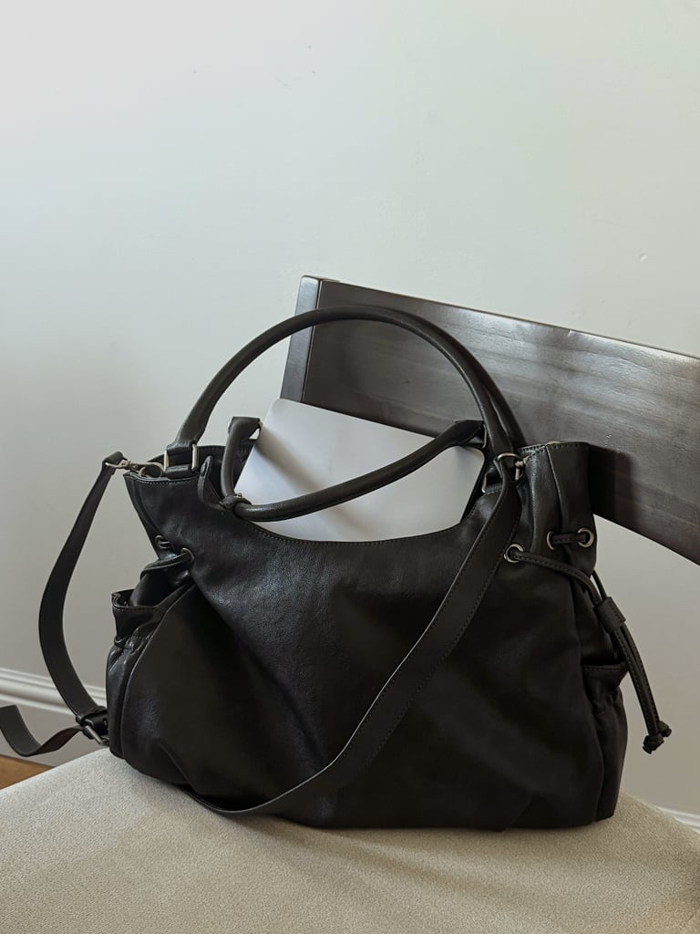 Stand Oil Breezy Bag ($135)
Charli XCX was spotted rocking this bag at Sundance Film Festival, and honestly, it stole the show. The smooth, glossy faux leather, slouchy silhouette, zip closure, and adjustable crossbody strap all make it effortlessly cool. Plus, the size is perfect for your Kindle, lip gloss, umbrella, and more. If your significant other has been hinting for a new bag, this one's a must.
Editor Quote: "Charli XCX may have sold me on this bag, but now that I own it, I'm here to sell it to you — it's worth every penny. As an editor, I'm always lugging my laptop around for the next story, and this bag handles it like a pro. Stylish, functional, and the color goes with basically everything. And honestly? For a bag this good, the price is a steal." — Haley Lyndes, shopping staff writer