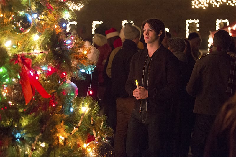 Jeremy (Steven R. McQueen) holds a candle by the tree. There are a lot of people he could be praying for, but I'm guessing it's Bonnie this time.