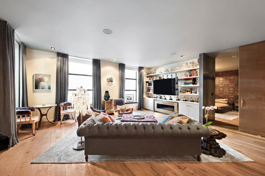 From this angle, you get a glimpse of the back of the couple's beautiful tufted sofa and, more importantly, their bedroom.