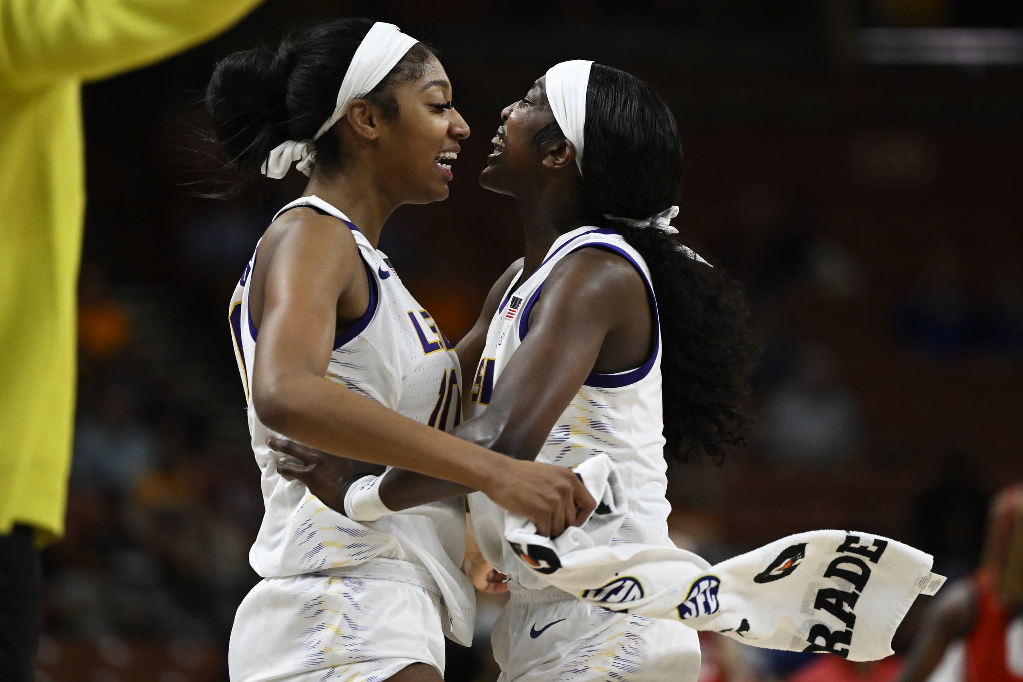 GREENVILLE, SOUTH CAROLINA - MARCH 03: Angel Reese #10 hugs Flau'jae Johnson #4 of the LSU Lady Tigers after her buzzer beater three point basket to end the third quarter during the quarterfinals of the SEC Women's Basketball Tournament at Bon Secours Wellness Arena on March 03, 2023 in Greenville, South Carolina. (Photo by Eakin Howard/Getty Images)