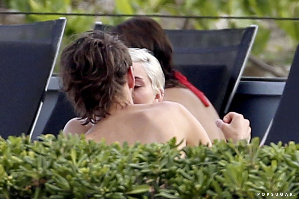 Miley Cyrus got very friendly with her close pal and personal assistant, Cheyne Thomas, when the two hit up a hotel pool in Barcelona on Thursday. The "Wrecking Ball" singer, who is traveling around Europe on her Bangerz tour, donned a red string bikini and danced around the pool area while partying with a group of friends. At one point, Miley and Cheyne were seen sharing what looks like a kiss, but it might have just been a spur-of-the-moment smooch, as Miley and her party were clearly in a fun mood. Besides, Miley and Cheyne clearly have a very close relationship — the songstress famously raised eyebrows when she grinded against a Santa-suit-wearing Cheyne at a Jingle Ball concert last year. Back in 2012, one of Miley's pool trips with Cheyne sparked rumors that she was cheating on then-fiancé Liam Hemsworth. Miley was forced to defend herself on Twitter, writing, "So now because I am engaged I can't have a friend of the opposite sex? Can't have a friend help me out while I'm working alllll day? #dumb."