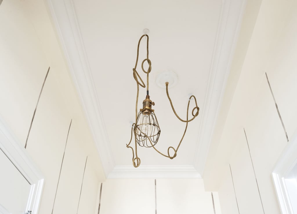 The entryway is proof rental lighting doesn't have to be boring. For an industrial touch, you can find a similar light fixture here.  Photo by  Matthew Williams via LABLstudio 