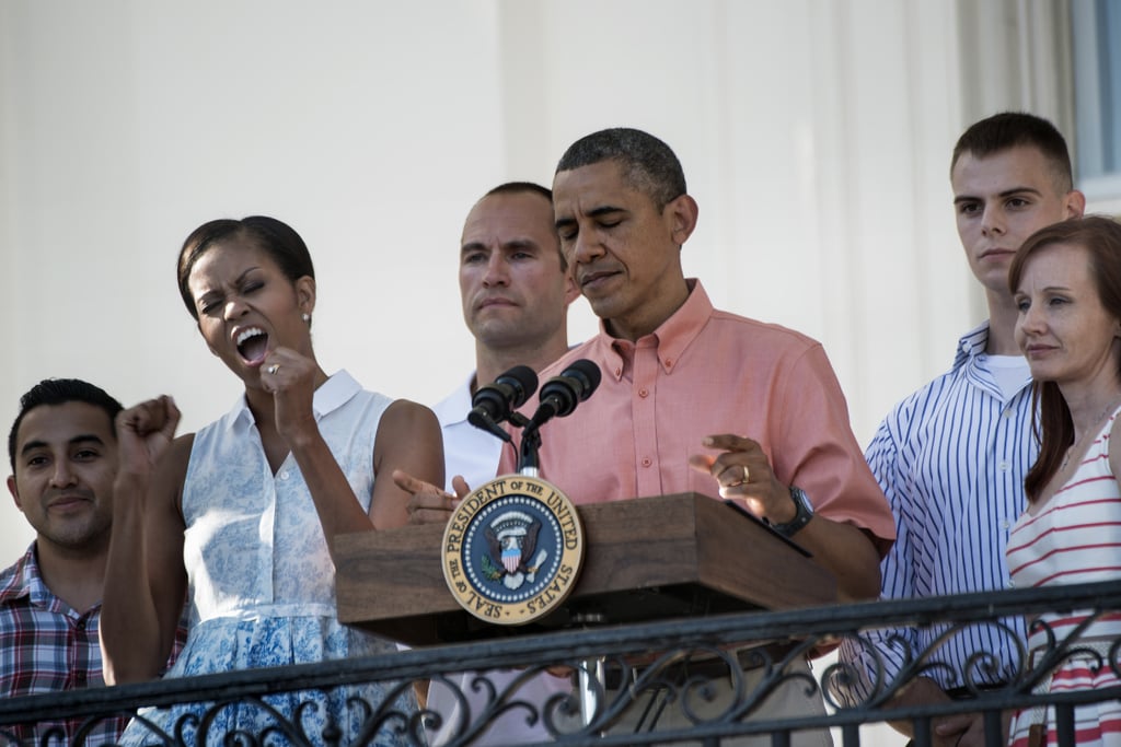 Michelle Obama cheered while President Obama addressed members of the military and their families at the 2013 White House BBQ.