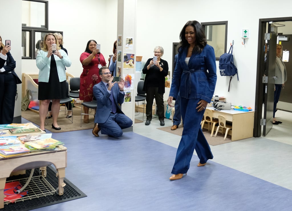 While visiting students in Los Angeles in 2018, she stunned in an all-denim look comprised of wide leg jeans, a matching belted jacket worn over a simple white top, and pumps.