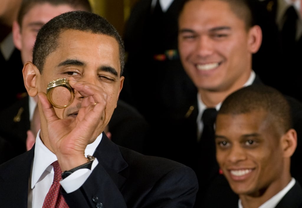 Inspecting a replica of the championship ring given to the Naval Academy football team in 2009.