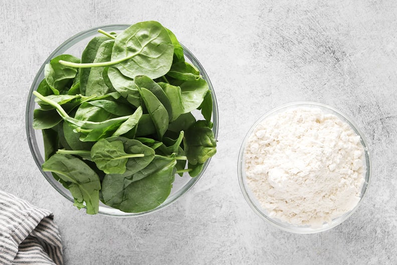 Spinach leaves and flour in bowls