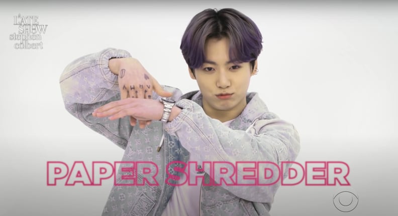 Jungkook From BTS Doing a "Paper Shredder" Hand Gesture