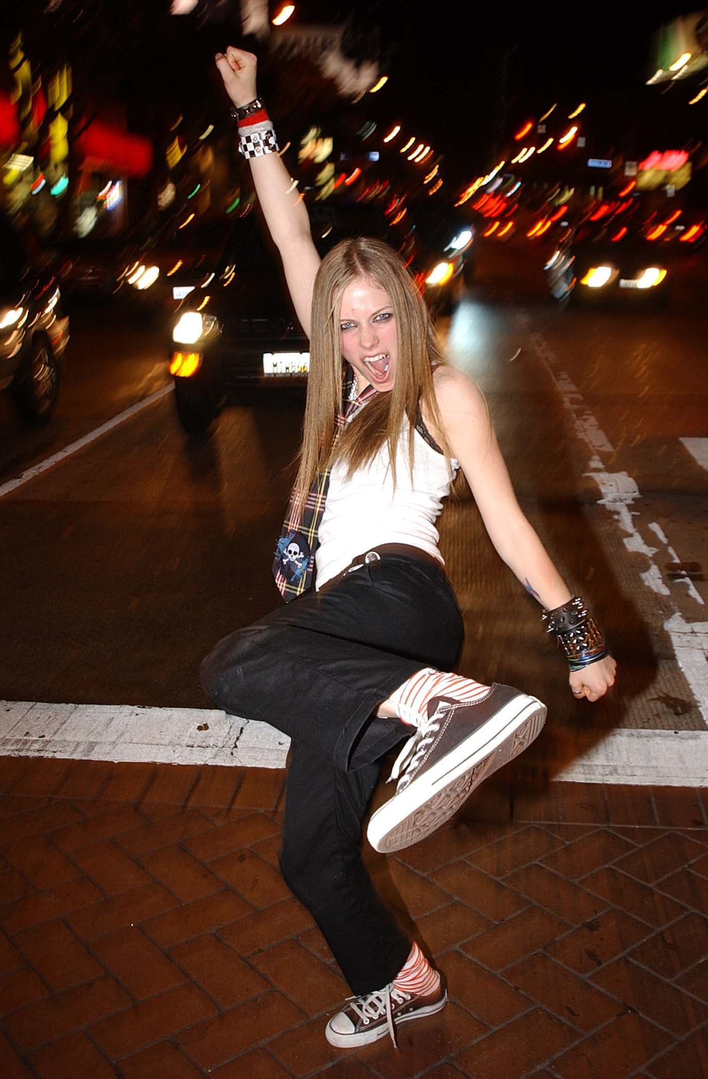 She loved to style a classic white tank top with Converse sneakers. | These  2000s Outfits Prove That Avril Lavigne Was the Ultimate 