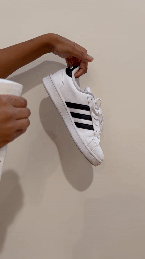 Gif of woman spraying the Jason Markk Repel Spray on a white Adidas sneaker.
