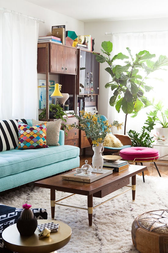 The teal couch and mermaid-scale pillow in this airy ...
