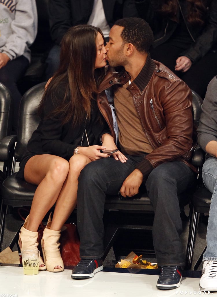 John Legend and Chrissy Teigen kept themselves occupied at a Lakers game in February 2011. John Legend and Chrissy Teigen kept themselves occupied at a Lakers game in February 2011.