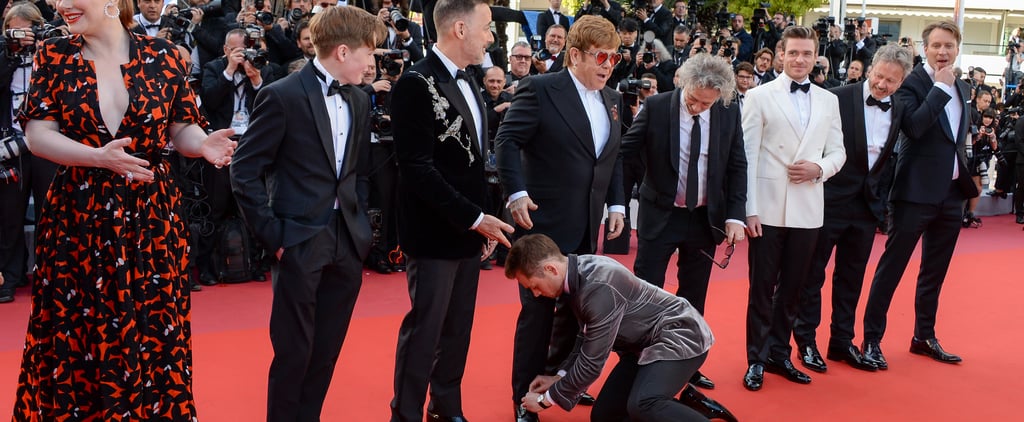 Taron Egerton Tying Elton John's Shoe Cannes Film Festival