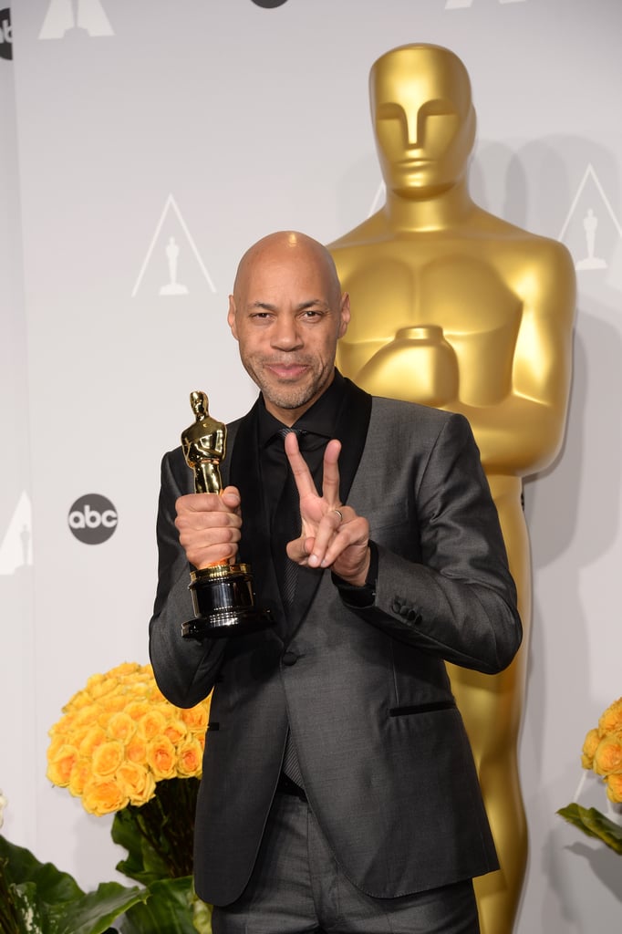 12 Years a Slave writer John Ridley flashed a peace sign with his Oscar for best adapted screenplay.