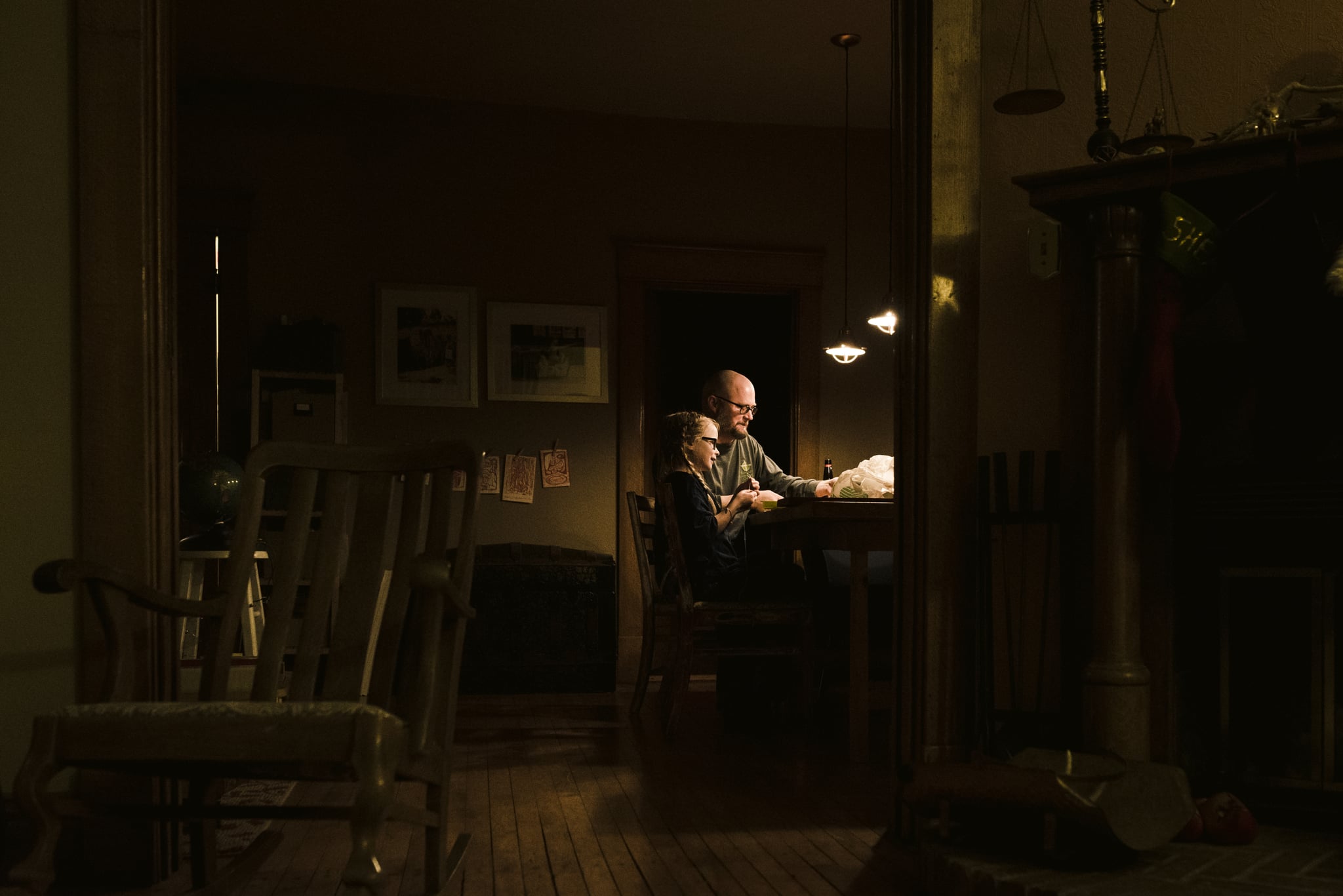 dad and daughter doing homework together at the dining table