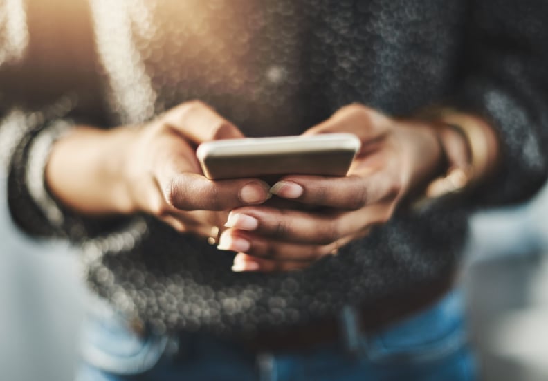 Cropped shot of an unrecognizable woman using a cellphone