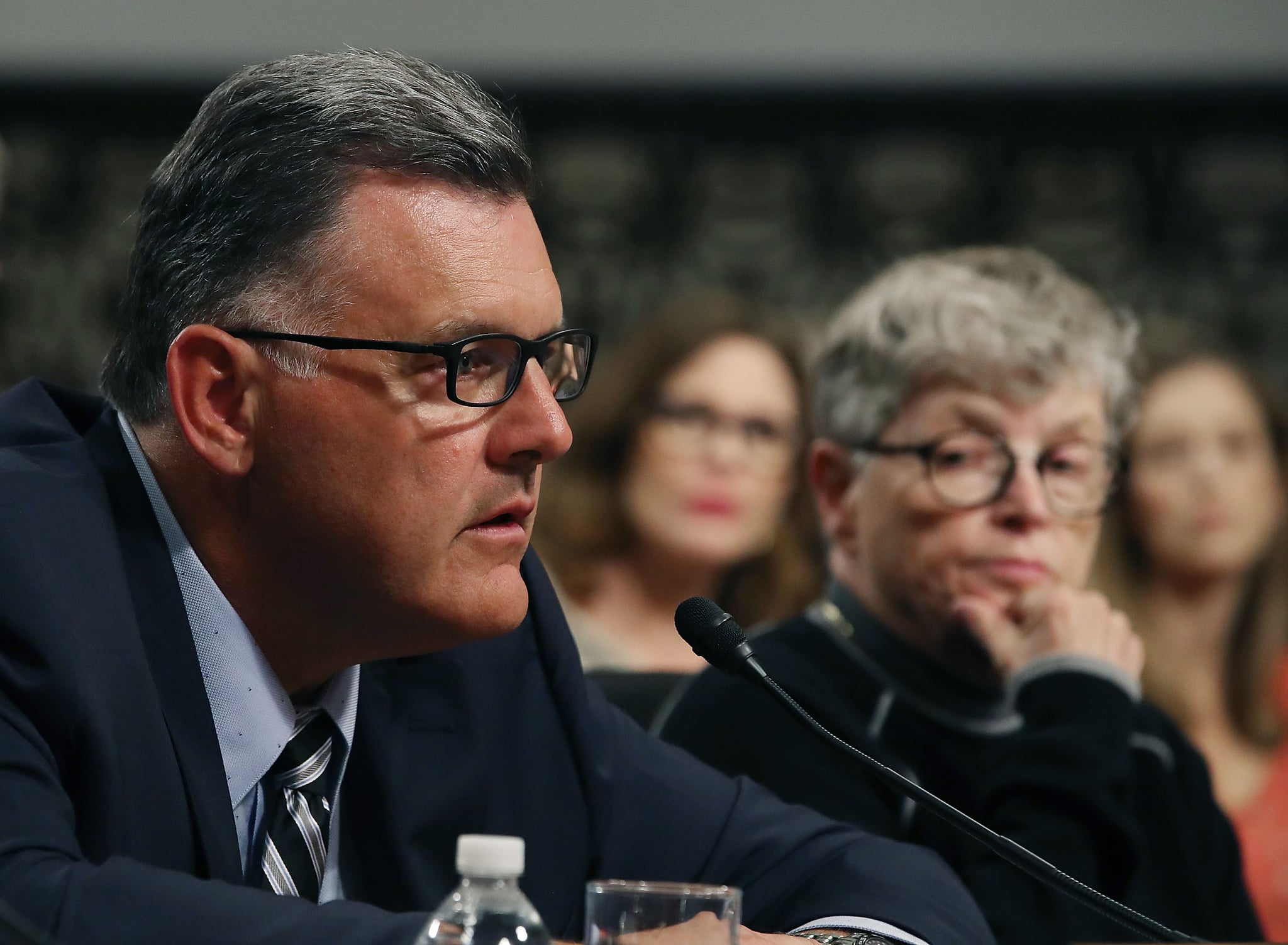 WASHINGTON, DC - JUNE 05: Steve Penny, former president of USA Gymnastics, pleads the Fifth, while seated next to Lou Anna Simon,(R), former president of Michigan State University, during a Senate Commerce, Science and Transportation Committee hearing, on June 5, 2018 in Washington, DC. The hearing focussed on preventing abuse in Olympic and amateur athletics and ensuring a safe and secure environment for athletes.  (Photo by Mark Wilson/Getty Images)
