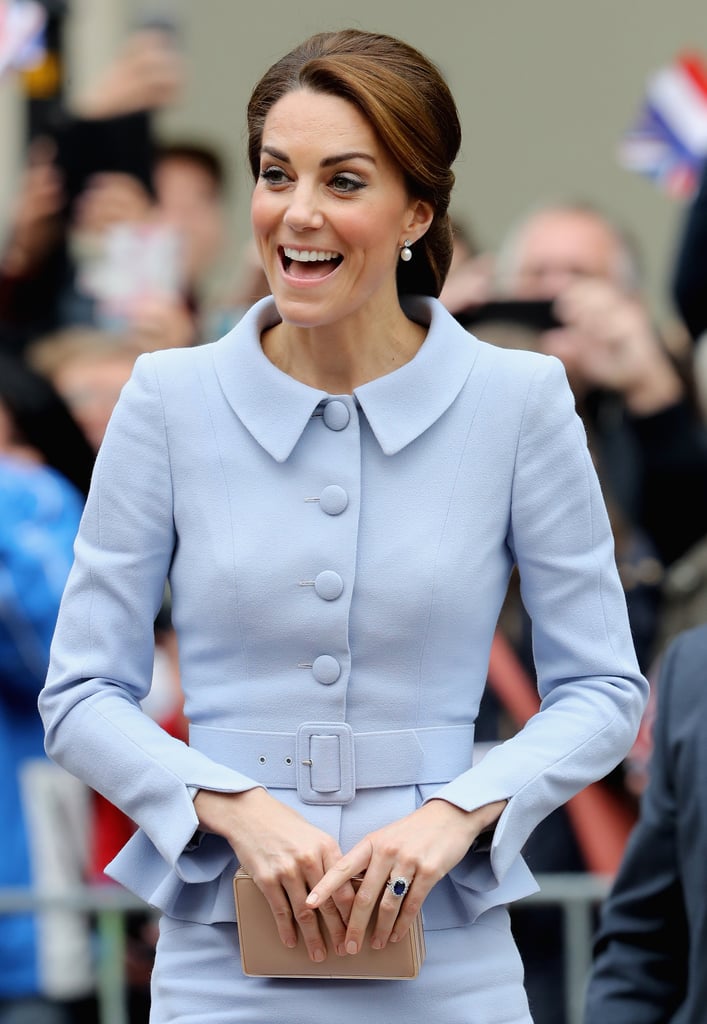 And she's off! Kate Middleton touched down in the Hague, Netherlands on Tuesday to embark on her first-ever solo tour since marrying Prince William five years ago. The Duchess of Cambridge flashed her signature smile while greeting some children outside of the Mauritshuis Gallery in a powder blue suit, and looked like she was already having a ball. After perfecting her princess wave, Mauritshuis Director Emilie Gordenker gave her a tour of the exhibition, "At Home in Holland: Vermeer and his Contemporaries from the British Royal Collection," which included a stop at Vermeer's famous "Girl With a Pearl Earring" oil painting. Kate also enjoyed the garden outside Villa Eikenhorst with King Willem Alexander before going indoors for a photo op.
Kate's tour of the Netherlands comes fresh off of her outing yesterday with William and Prince Harry on World Mental Health Day, and a few days after her and William's eight-day tour of Canada with their children. While in the Netherlands, Kate will spend time hosting a round-table discussion at the British ambassador's residence in The Hague with two of her charities, the Anna Freud Centre and Action on Addiction. Later on, she'll also visit the city of Rotterdam to see Bouwkeet, an initiative in an economically challenged district that aims to provide a workspace for creative design and technology. Not a bad start to her monumental visit!