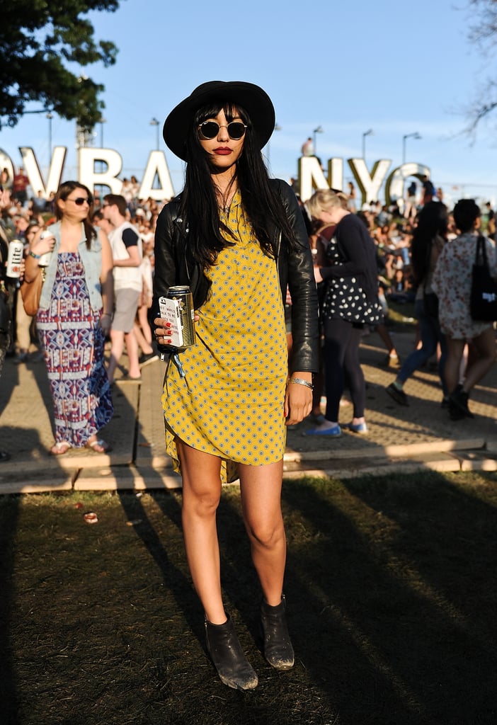 This music-lover added edginess to her look by pairing a yellow H&M dress with sleek accessories like a leather jacket, dark sunglasses, and a cool hat.