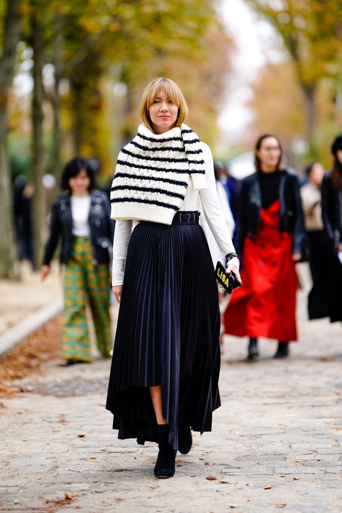 On chilly days, wrap a cream-and-navy striped sweater around your shoulders like a scarf.