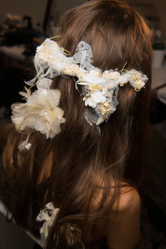 The hair accessories spotted backstage at Rodarte were every indie bride's dream, but the unspoken takeaway here was that you can gather lace, feathers, beads, or any other craft-worthy fabric to pull your hair back into an ethereal style sans hair elastic in five minutes flat.