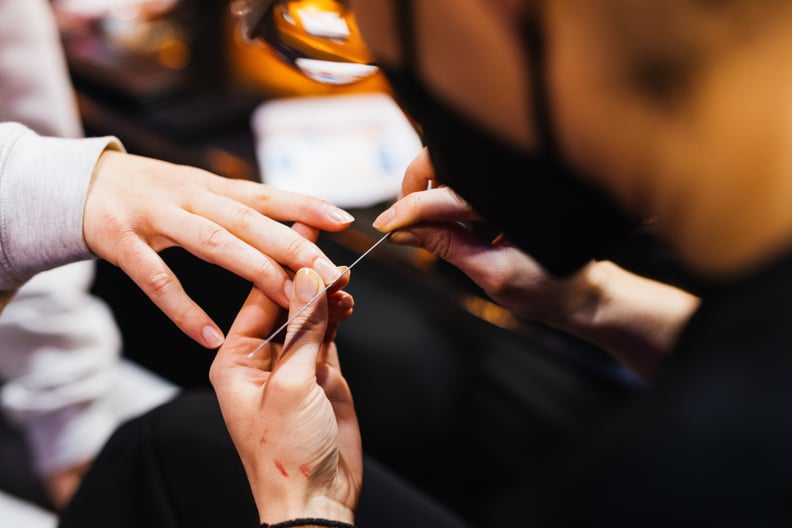 19 February 2022, Baden-Wuerttemberg, Rust: A contestant in the Miss Germany competition sits backstage having her fingernails filed. 160 contestants were invited to the so-called 