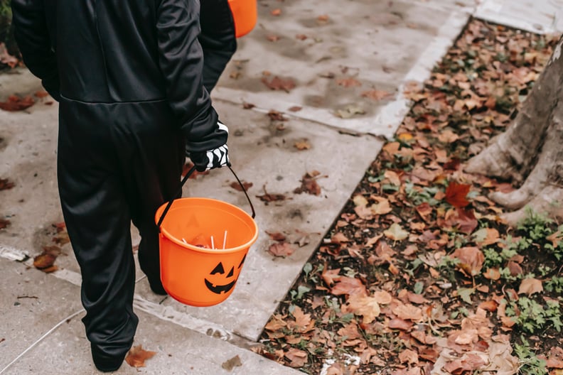 kids holding buckets of candy while trick-or-treating