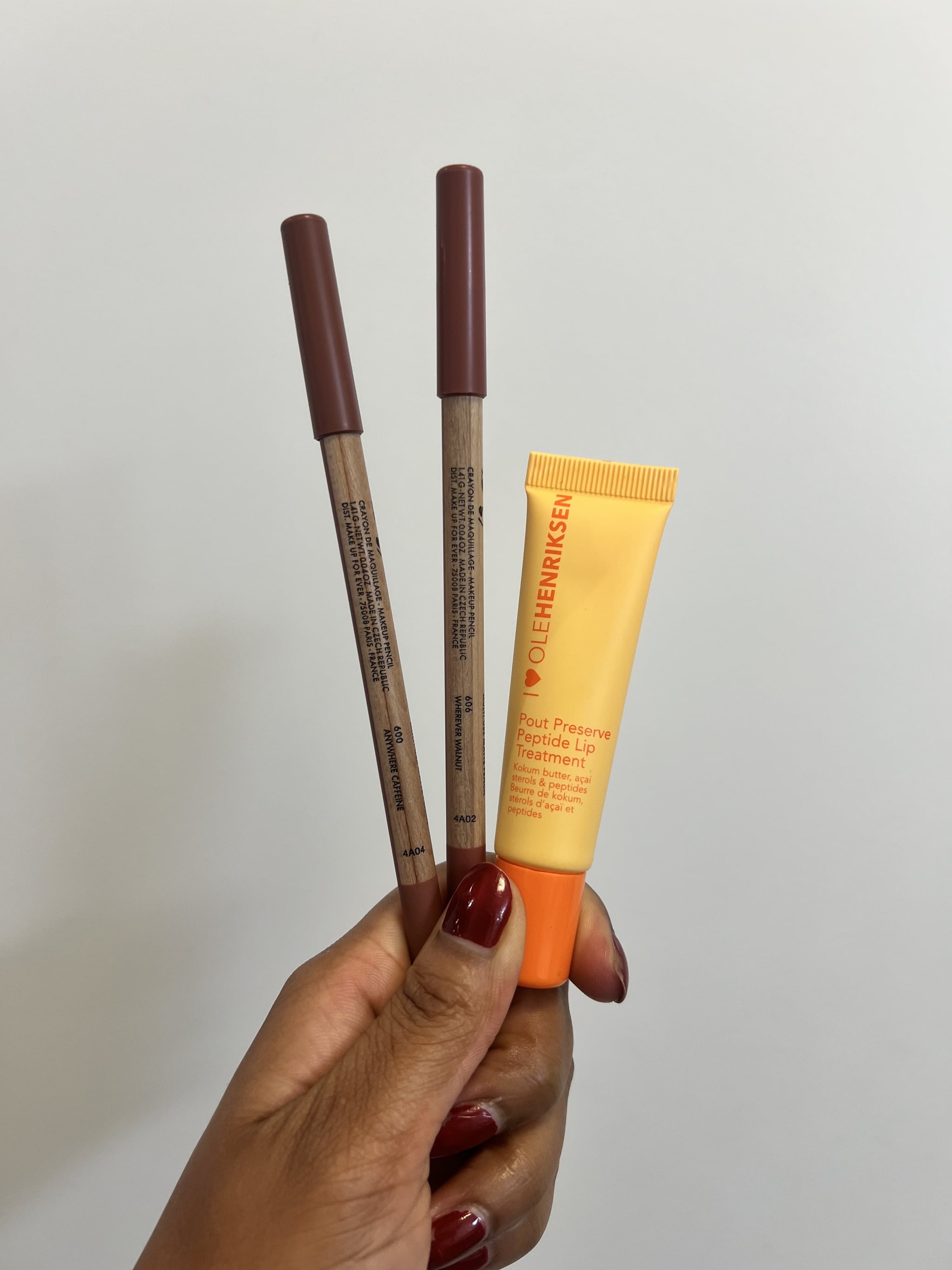The Make Up For Ever Artist Color Pencils in Anywhere Caffeine and Wherever Walnut, and Ole Henriksen Pout Preserve Peptide Lip Treatment in Original.