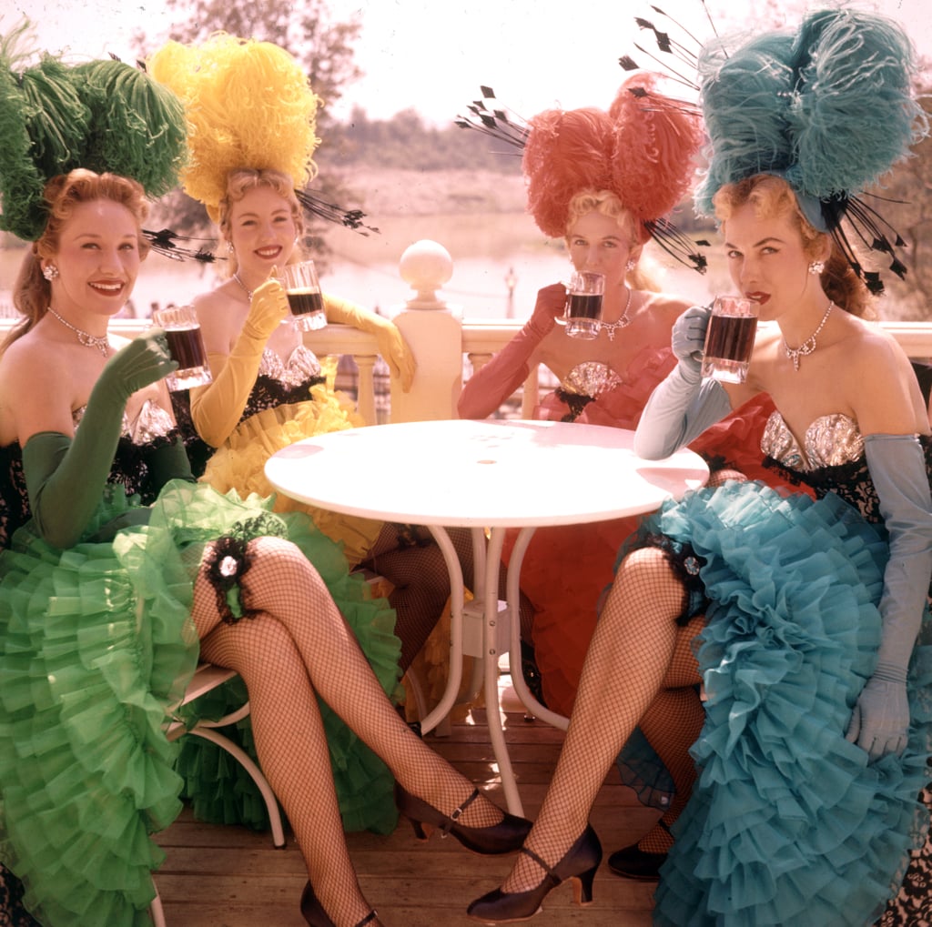 A group of showgirls sat outside the Golden Horseshoe saloon and enjoyed a cold drink to celebrate the opening.