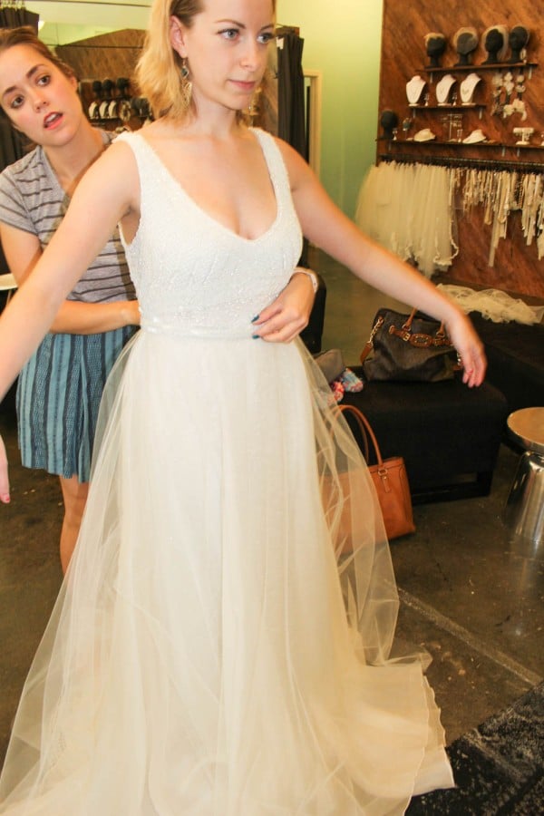 Marissa is trying on a fitted beaded gown by designer Theia White Couture. To add a bit more glam, she decided to pair the gown with a tulle skirt!